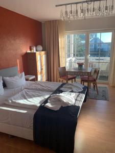 a bedroom with a bed and a dining room with a table at ART-hüs in Westerland (Sylt)