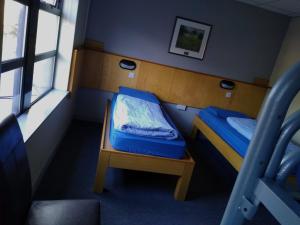 a bedroom with a bed and a window at Belfast International Youth Hostel in Belfast