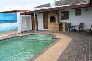 a swimming pool in front of a house at 34 On Marten Crescent in Table View