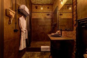 a bathroom with a shower and a sink at Mysterio Hotel in Saint Petersburg