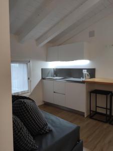 a kitchen with white cabinets and a counter top at Borgo di Ponte Holiday Apartments & Rooms in Cividale del Friuli