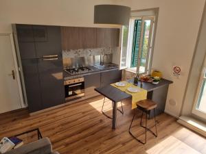 a kitchen with a table and a stove top oven at Giulia Butterfly in Bettolle