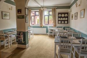 a dining room with tables and chairs and a window at Toothbrush Rooms at Lattice Lodge - Self Catering in Ipswich