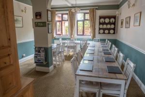 a room with a long table and chairs at Toothbrush Rooms at Lattice Lodge - Self Catering in Ipswich