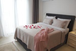 a bedroom with a bed with red flowers on it at Apartments Petar in Budva