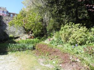 a garden with flowers and plants on a hill at Villa MONIKA in Dieppe