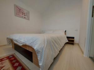 a bedroom with a bed with a white comforter at Roza Vânturilor in Socea +10 photos