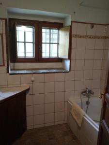 a bathroom with a bath tub and a window at Gîte Ciel Bleu Château d'Allemagne En Provence in Allemagne-en-Provence