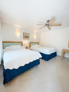 Ένα ή περισσότερα κρεβάτια σε δωμάτιο στο Hotel Cocoplum Beach