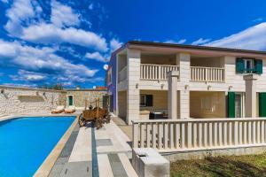 a villa with a swimming pool and a house at Villa AnBer in KoruÅ¡ce