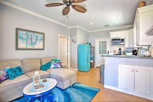 a living room with a couch and a kitchen at Pet-Friendly Lakefront Getaway with Hot Tub! in Coffee City