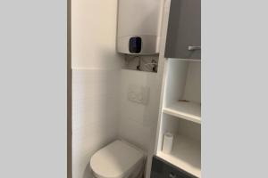 a small bathroom with a toilet and a sink at Skolas street seaside space! in Jūrmala