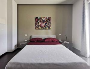 a bedroom with a large bed and a painting on the wall at Green Land B&B Boutique in Castilenti