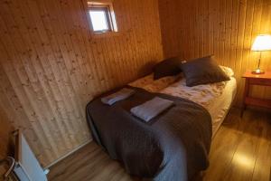 A bed or beds in a room at Fossatún Sunset Cottage