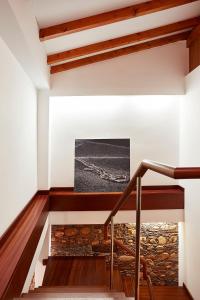 a staircase in a house with a stone fireplace at Casa da Pedra Rolada in Janeiro de Cima