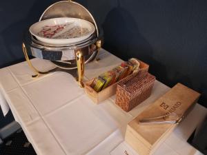 a table with a pot and a box of candy at Hotel Goldener Schlüssel in Altdorf +47 photos