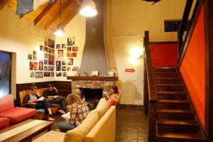 a group of people sitting in a living room at Condor De Los Andes in El Chalten