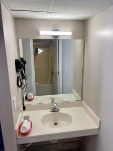 a bathroom with a sink with a large mirror at Smoky View Inn in Pigeon Forge