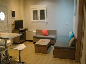 a small living room with a couch and a table at Villa Eleftheria in Vitalades