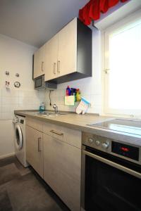 a kitchen with a sink and a dishwasher at Ferienwohnung SEE - ZEIT in Immenstaad am Bodensee