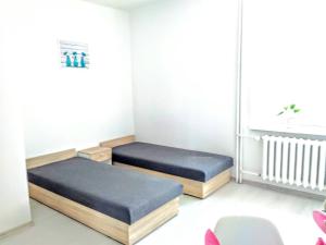 a room with two beds and a window at Studio Centrum - 1 Maja 16 in Zabrze