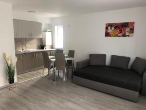 a living room with a couch and a table at Elena-Maria Apartments in Buşteni