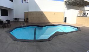 a swimming pool in the middle of a building at Hotel Algas Marinhas in Aracaju