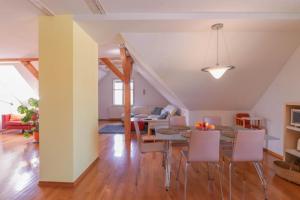 a dining room and living room with a table and chairs at Apartment in the heart of Bled with views in Bled