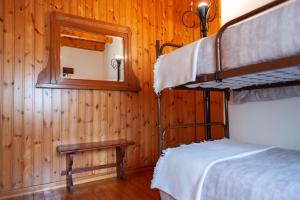 a bedroom with two bunk beds and a mirror at Casa Vacanza Scacco d' Argento in Boario Terme +51 photos