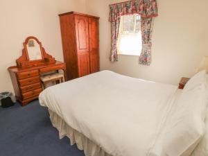 En eller flere senge i et værelse på Blueberry Cottage