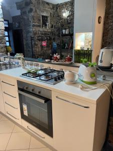a kitchen with a stove and a counter top at Antica Casa Centro in Catania