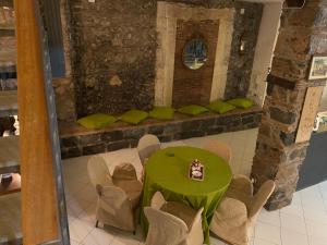 a room with a green table and some chairs at Antica Casa Centro in Catania