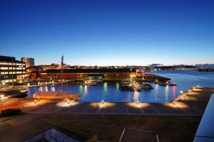 a view of a marina at night with boats in the water at Stavanger Small Apartments - City Centre in Stavanger