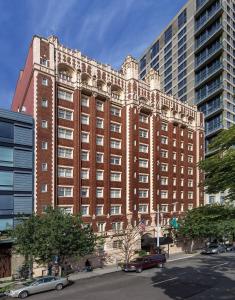 a large brick building with cars parked in front of it at WorldMark Seattle - The Camlin in Seattle