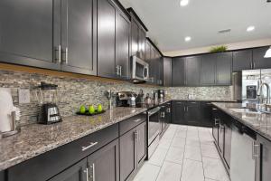 a kitchen with black cabinets and marble counter tops at Havilah Vacation Villas Resort Club in Davenport