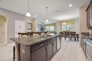 an open kitchen and dining room with a large island at Havilah Vacation Villas Resort Club in Davenport