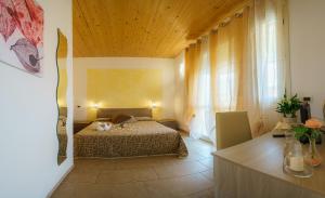 Posteľ alebo postele v izbe v ubytovaní Albergo La Lampara + 37 fotografií