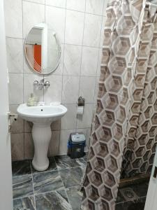 a bathroom with a sink and a mirror at Apartments Stone in Struga