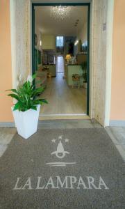 an entrance to a building with a sign on the floor at Albergo La Lampara in Marina di Cecina