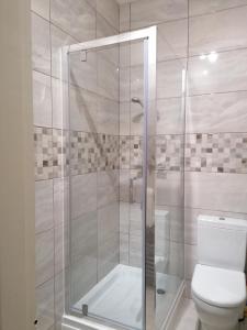 a bathroom with a shower and a toilet at Great location, quiet yet 5 mins to Bowness centre with walks from the door and parking in Bowness-on-Windermere