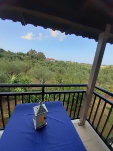 a blue table with a light on a balcony at Katerina Studios in Laganas