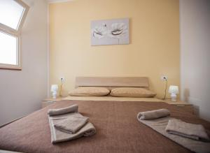 a bedroom with a bed with two towels on it at Borgo Marino in Castel di Tusa
