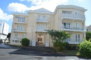 a large apartment building with a street in front of it at Well equipped peaceful 3 bedroom apartment in Flic-en-Flac