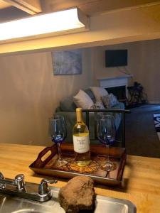 a tray with a bottle of wine and two wine glasses at #Cozy2BrVilla in Lintonia - NearStone MTN Park in Lithonia