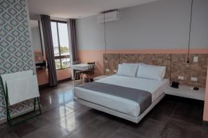 a bedroom with a bed and a desk in it at Hotel G in Santa Cruz de la Sierra