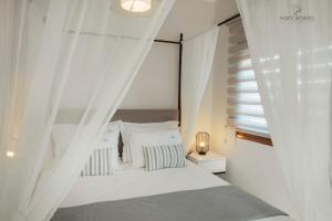 Krevet ili kreveti u jedinici u objektu PORTO PORTES suites