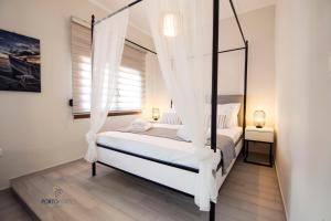 Krevet ili kreveti u jedinici u objektu PORTO PORTES suites