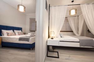 Krevet ili kreveti u jedinici u objektu PORTO PORTES suites