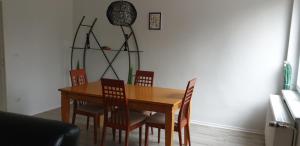 uma sala de jantar com uma mesa de madeira e cadeiras em Zwei Etagen Wohnung im Grünen em Berlim