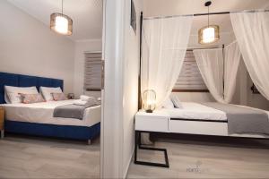 Krevet ili kreveti u jedinici u objektu PORTO PORTES suites